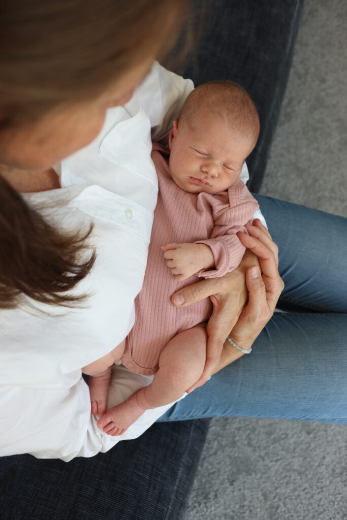 Baby Fotoshooting – Foto eines Babys auf den Arm seiner Mutter Foto eines Babys auf den Arm seiner Mutter